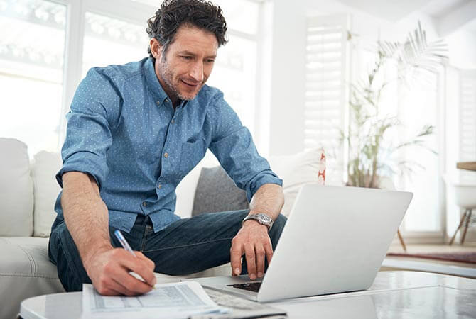man in living room using a laptop 