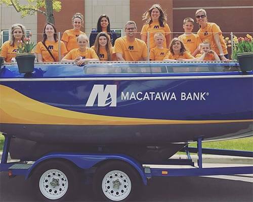 Macatawa Bank employees in Tulip time parade in our Boat float