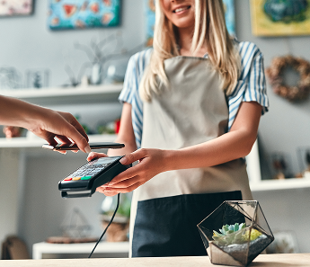 Woman using payment machine for her business