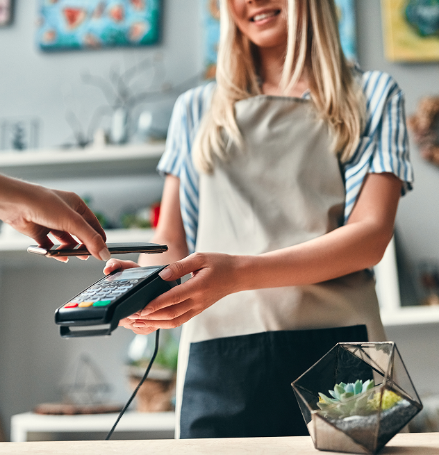 Woman using payment machine for her business