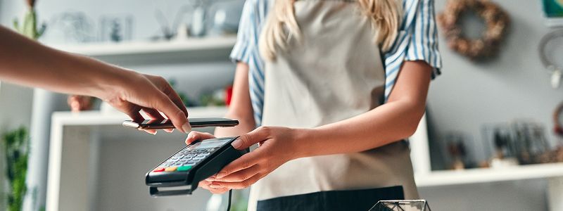 Woman using payment machine for her business